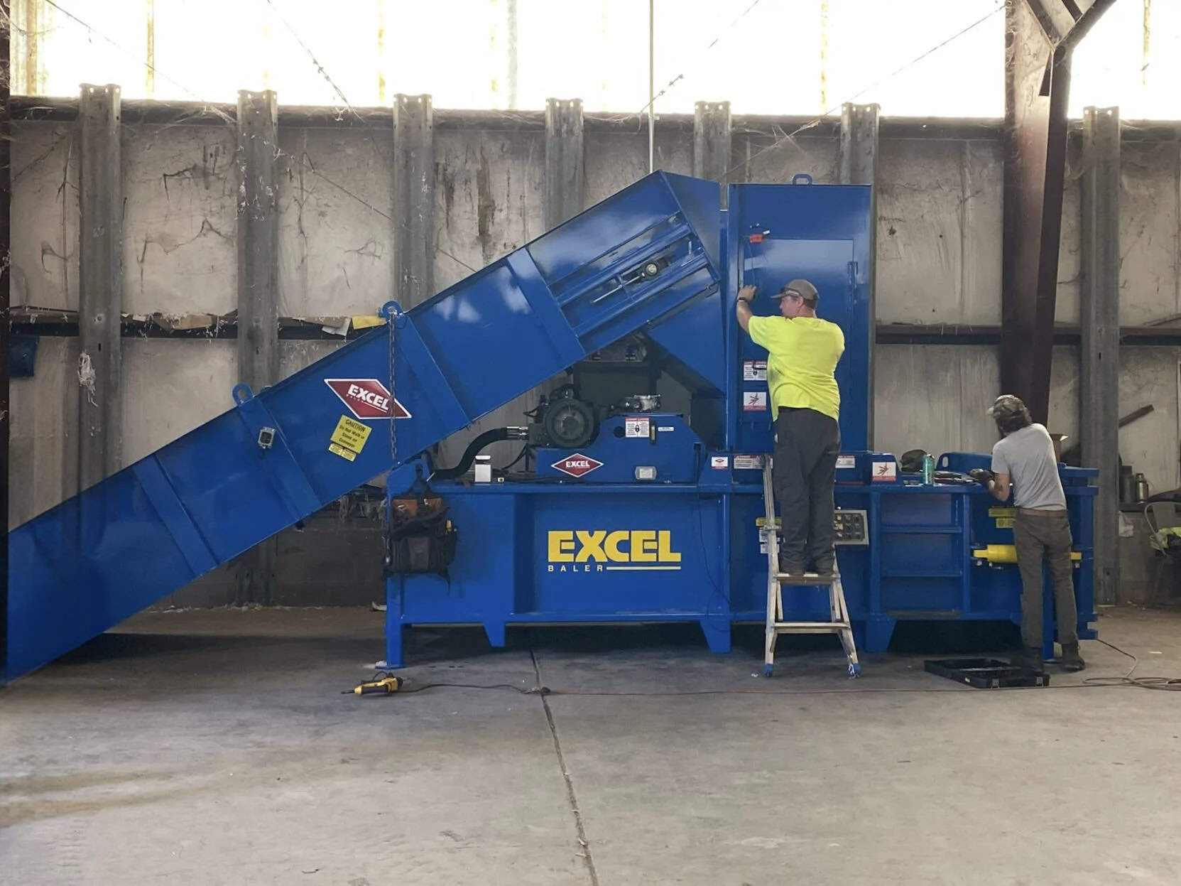 Reconditioned horizontal manual-tie baler rebuilt by HMS technicians
