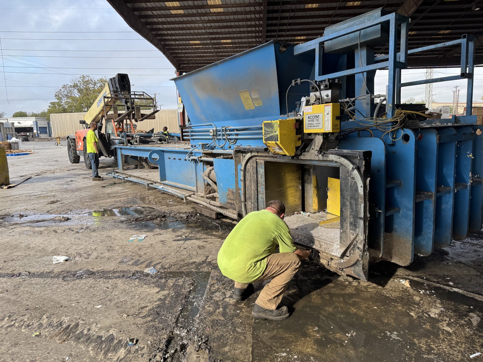 HMS technicians working on recycling equipment installation and service in the field