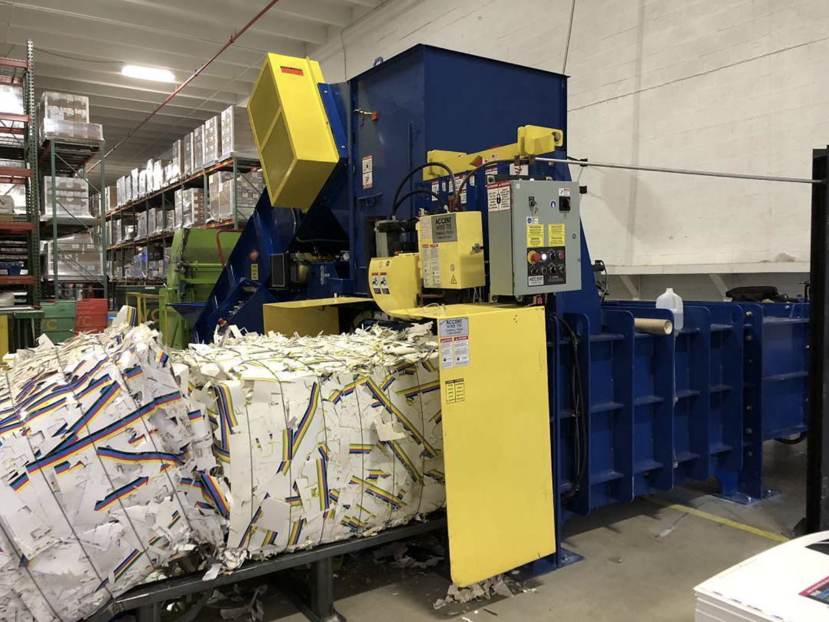 Excel 2R63D two-ram baler showing L-shaped dual cylinder configuration for high compaction force recycling operations