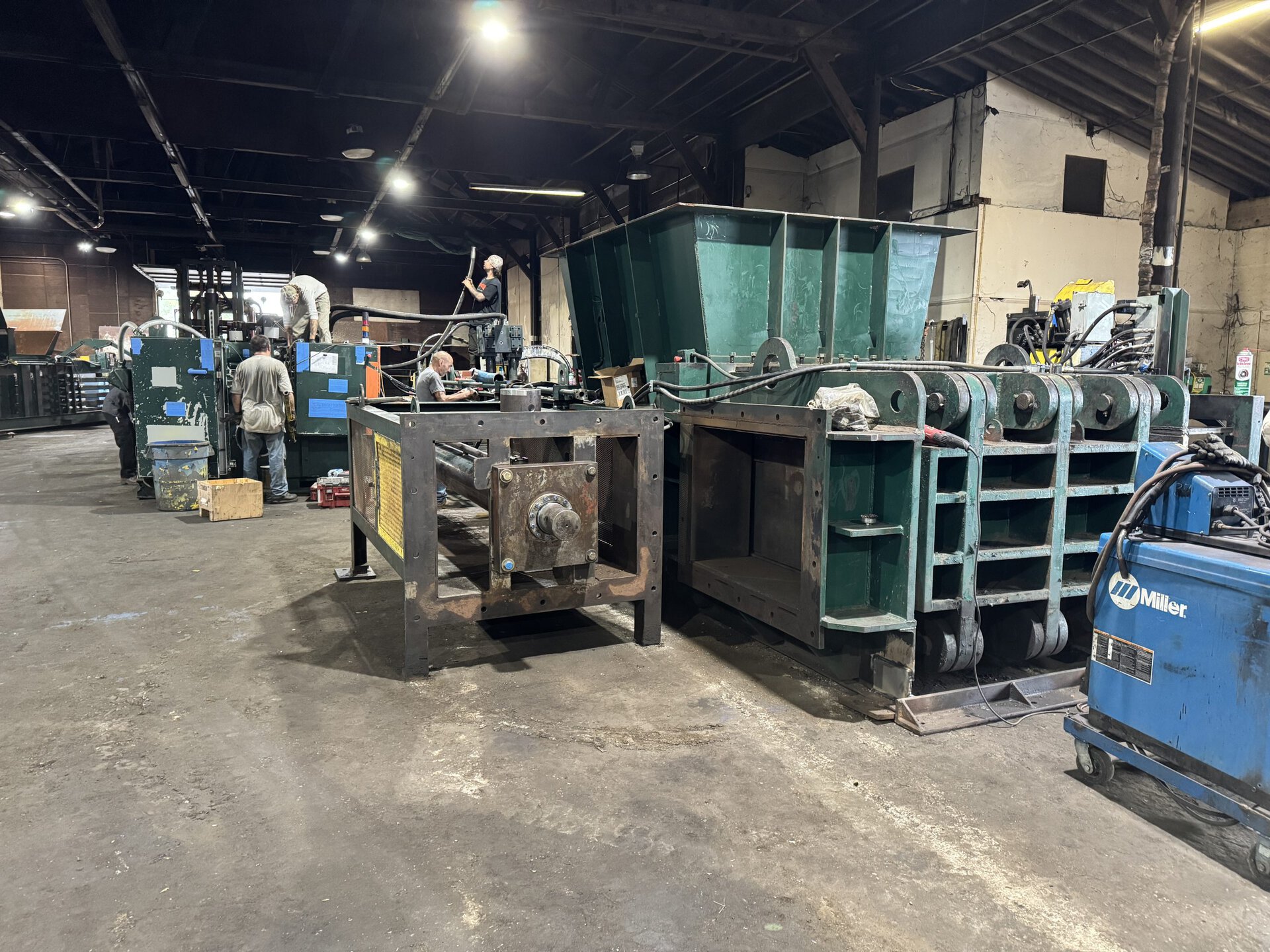 HMS technician rebuilding used recycling baler at Hoosier Machinery Solutions facility Wanatah Indiana