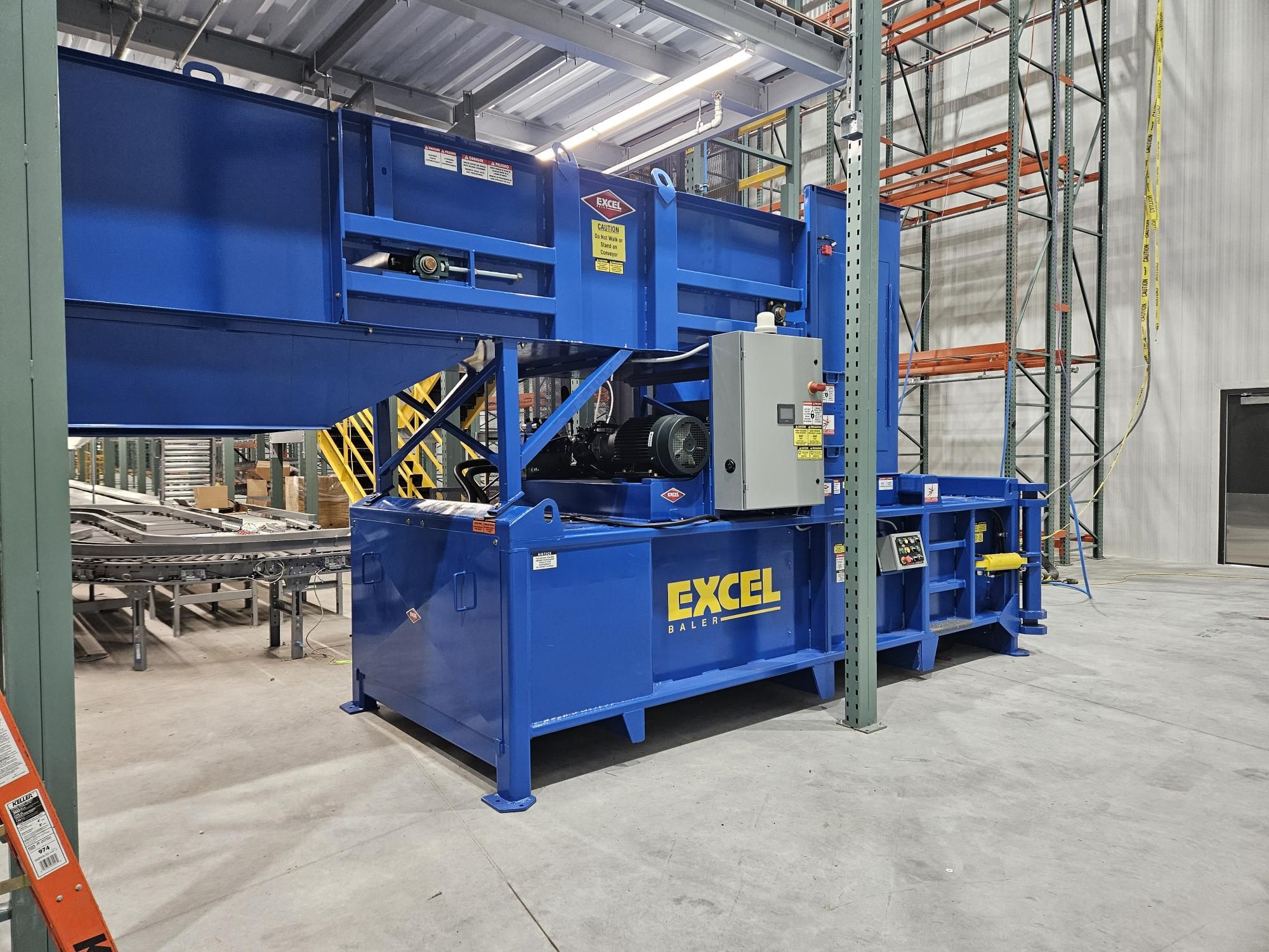 Completed baler installation at distribution center HMS turnkey system including baler and conveyor infeed