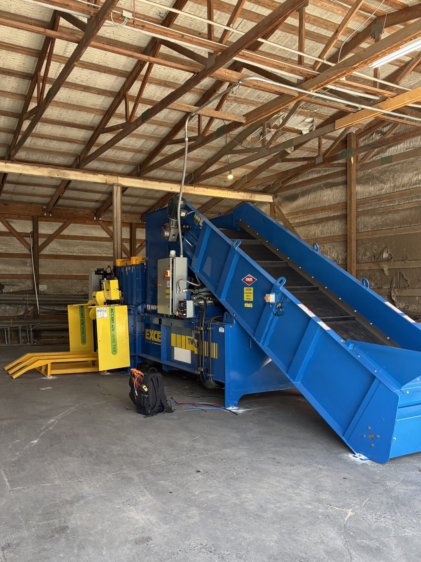 HMS custom baler infeed conveyor system feeding material into horizontal auto-tie baler at customer facility