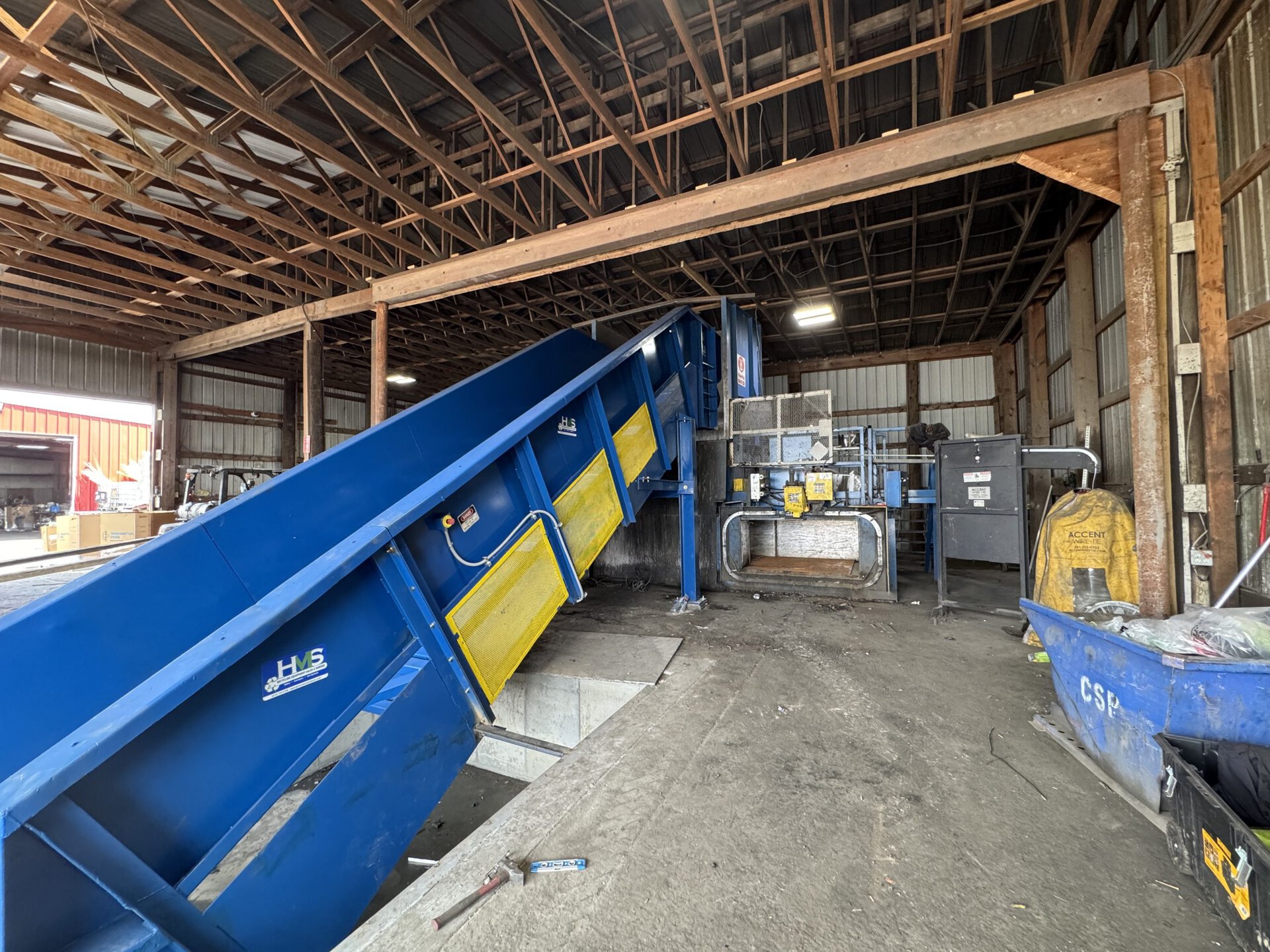 Two ram scrap metal baler with HMS refurbished Hustler infeed conveyor for non-ferrous processing at scrap yard